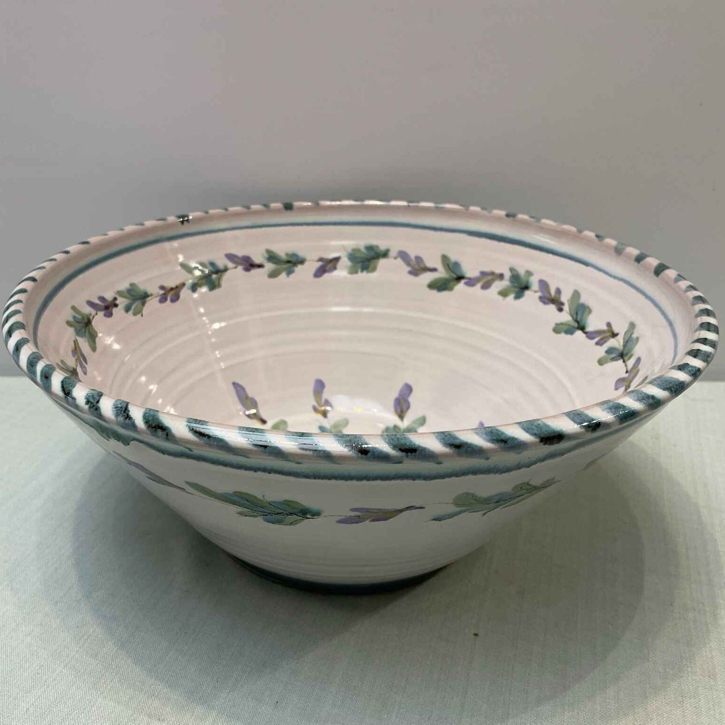 Decorative ceramic bowl with floral patterns on a white surface