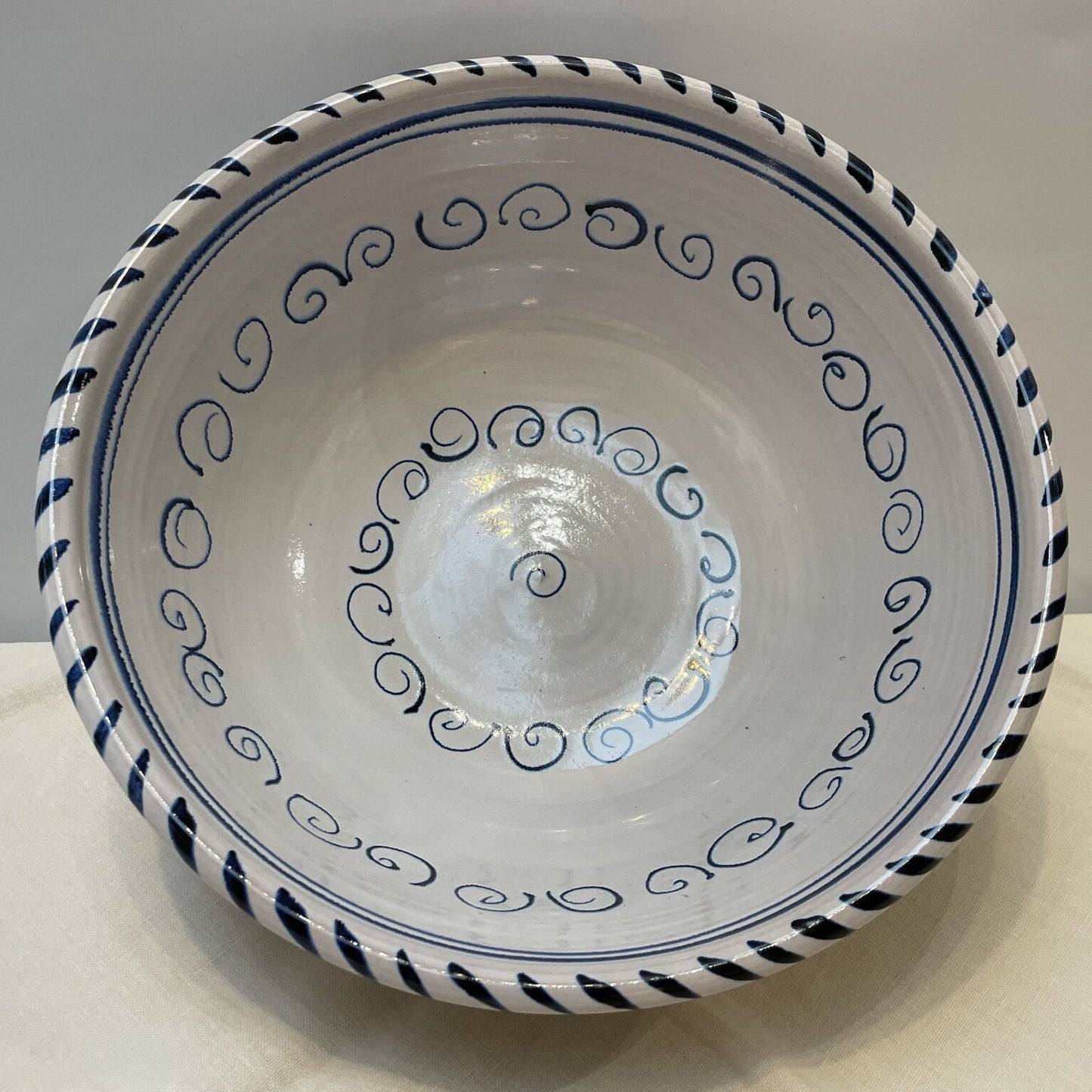 Ceramic bowl with blue decorative patterns on a white background