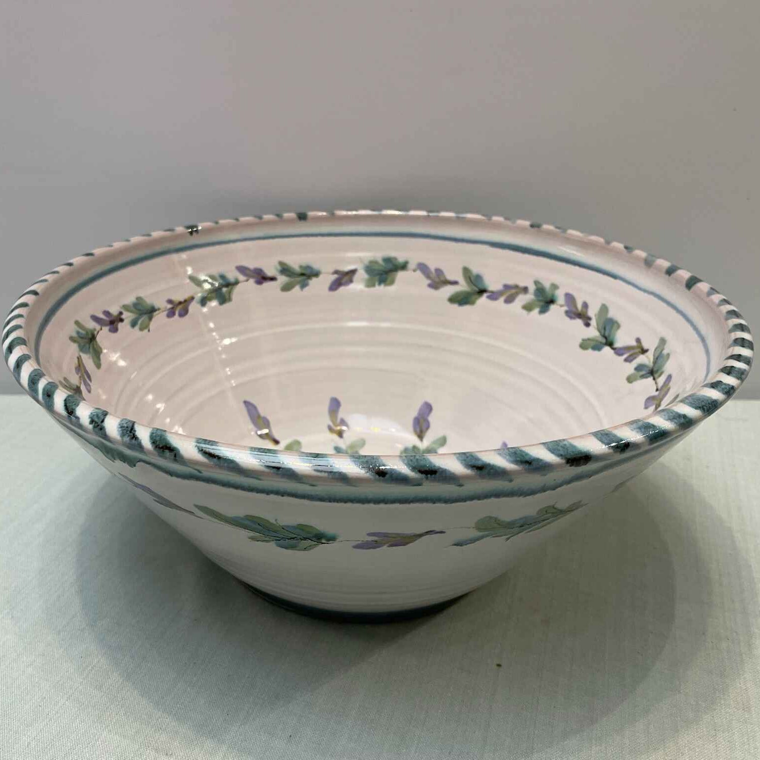 Decorative ceramic bowl with floral patterns on a white surface
