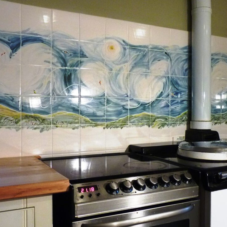Kitchen with artistic tile mural on the wall